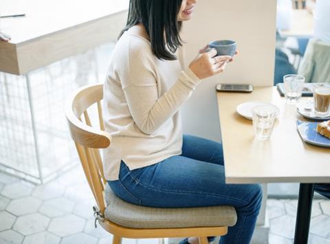 Young woman sitting at a desk at work 