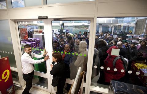 AT THE DOORS: Crowds of excited shoppers wait outside the Asda store in Wembley for the highly anticipated Black Friday sales. This years offers are 3 x times bigger and better than last year, with double the number of ranges on offer in 441 of its stores