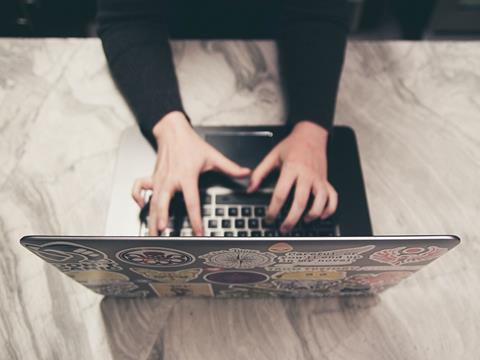 Young person online with laptop