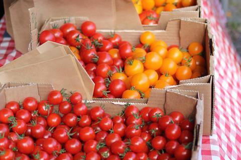 loose tomatoes market stall vegetables