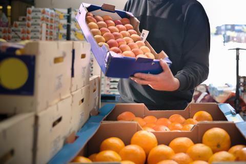 fruit suppliers crate peach orange farmer GettyImages-129300369