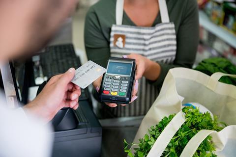 Card payment supermarket cashier till checkout GettyImages-1349881366