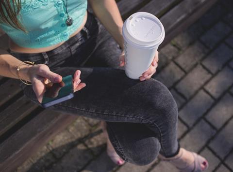 girl on phone drinking coffee starbucks