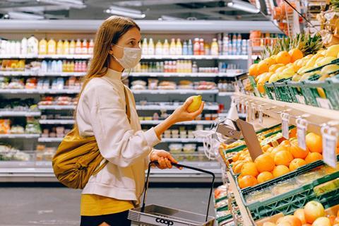 woman-in-yellow-tshirt-and-beige-jacket-holding-a-fruit-3962285