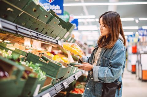 woman in supermarket - getty