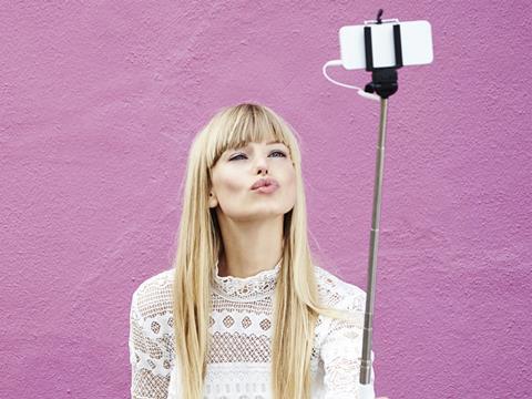 Young woman taking a selfie with her mobile phone