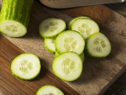 Cucumber cut up on a wooden chopping board