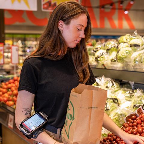 Grocery store worker using smart technology solutions