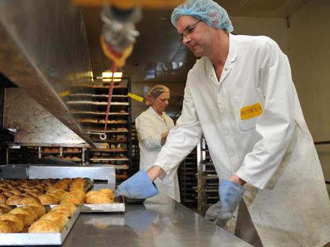 WC Rowe makes living wage commitment, man in bakery baking bread