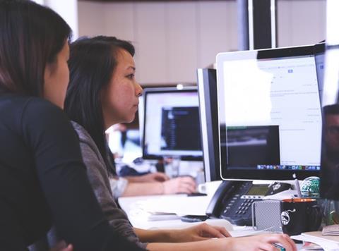 women working together on computer