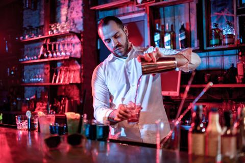 Man pouring cocktails in a bar