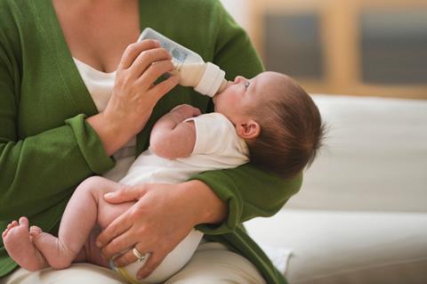 Mother bottle feeding baby