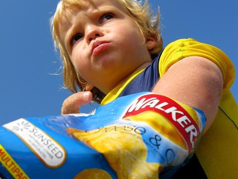 child eating crisps