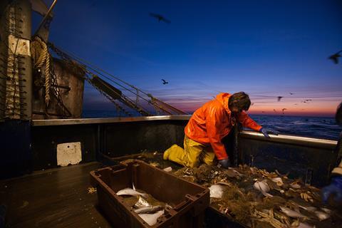 Trawler fishing at night - stock photo