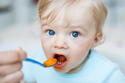 Baby being spoon-fed