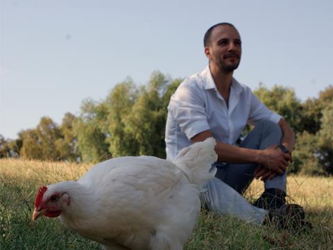 Ido Savir of lab-grown meat startup Supermeat shown with a chicken