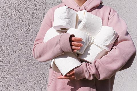 woman-in-pink-long-sleeve-hoodie-carrying-tissue-rolls-3962433