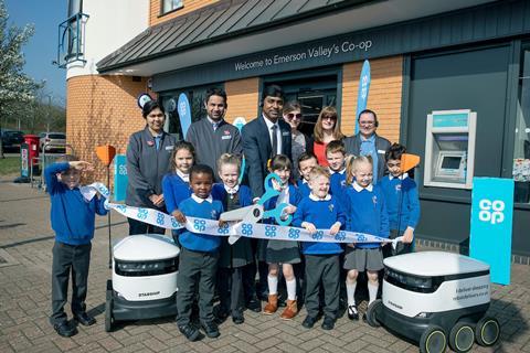 Co Op Opening Emerson Valley Milton Keynes with Delivery Robots and, children from Howe Park School help with ribbon cutting along with