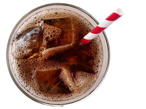 fizzy cola drink with straw shot from above