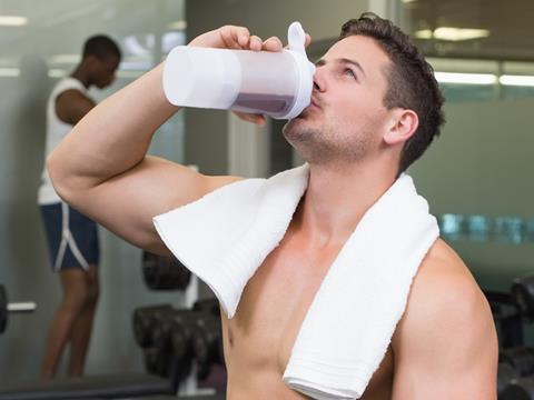 man drinking protein shake gym