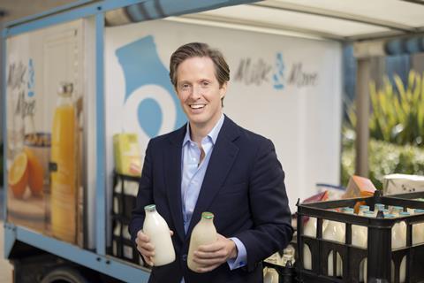 Patrick Müller, CEO for Milk & More holding two bottles