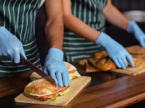 staff workers making sandwiches 