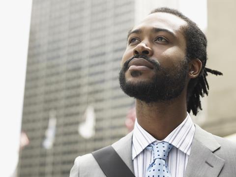 Young smartly dressed businessman looking up towards the sky_career_ambition_aspiration