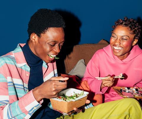 Two friends eating sushi together