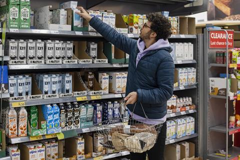 man browsing in dairy alternative milk aisle