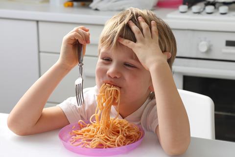 child kid eating meal spaghetti pasta dinner children family GettyImages-1138727508