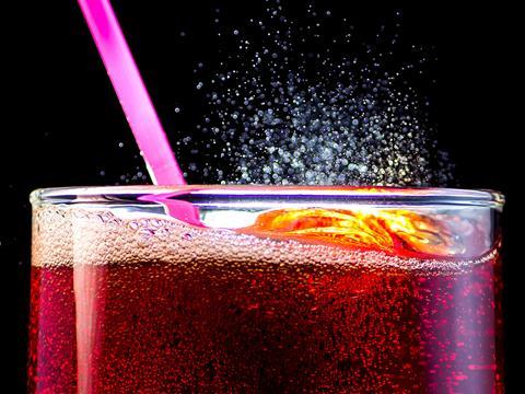 Fizzy cola drink with straw