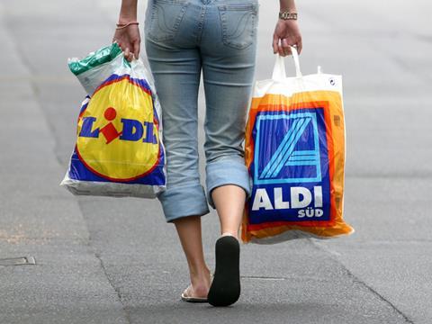 woman shopper with aldi and lidl carrier bags one use