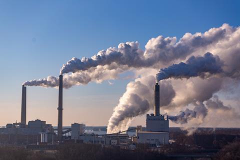 Factory emitting plumes of smoke
