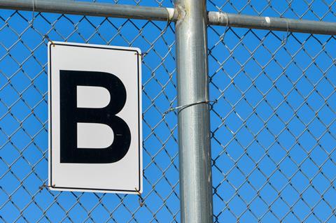 Letter B on wire fence