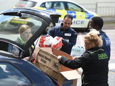 Asda staff distribute food and drink for the victims of the Manchester concert attack