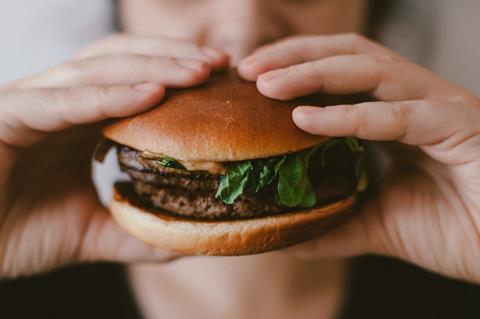 Person holding burger meat-free 
