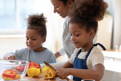 Mother and children cooking vegetables