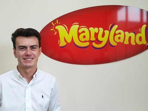 Tom Williams of Burtons Biscuits in front of a Maryland Cookies banner