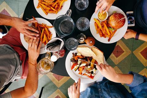 people eating burgers and chips meal restaurant