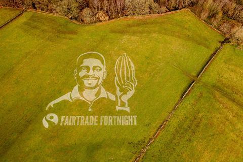 A grass art painting in Yorkshire, depicting Ghanaian cocoa farmer Bismark Kpabitey, created to mark Fairtrade Fortnight. Credit- Sand In Your Eye