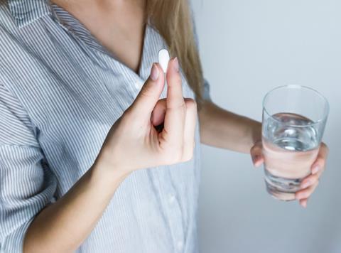 woman taking pill tablet medicine otc