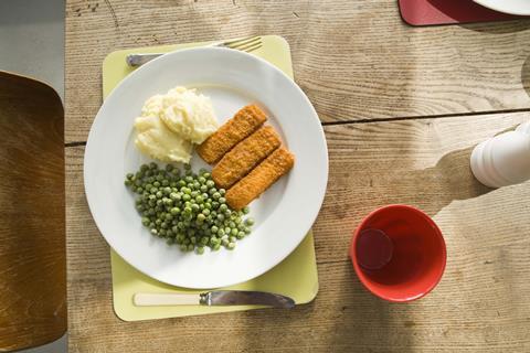 Fish fingers peas frozen food meal plate table
