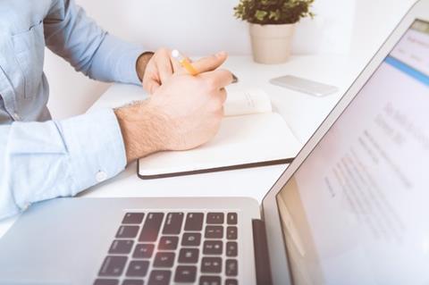 man at laptop writing