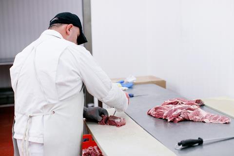 Meat processing factory worker butcher