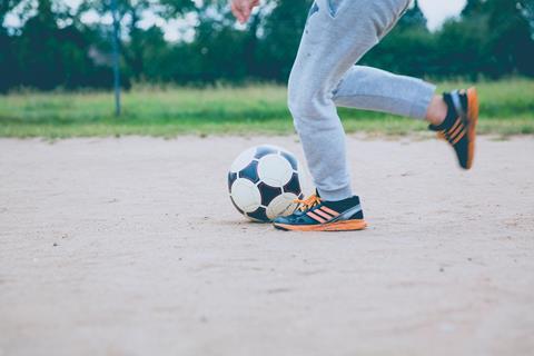 child playing football exercise