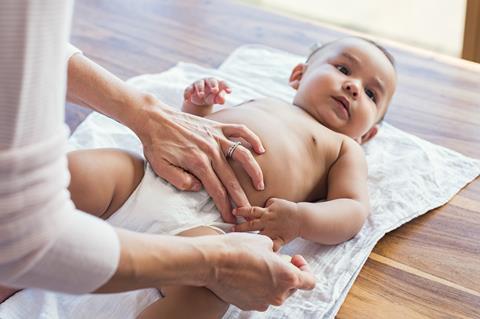 Baby wearing a nappy on a changing mat