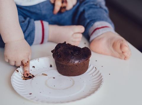 child eating chocolate cake