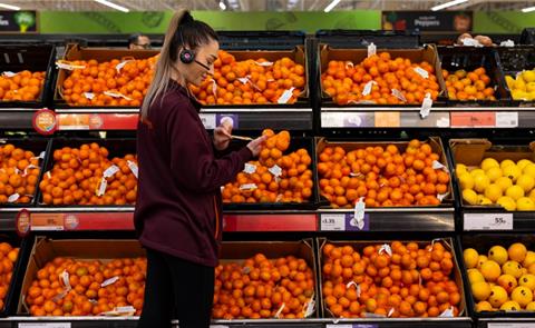 sainsburys worker staff oranges fruit aisle