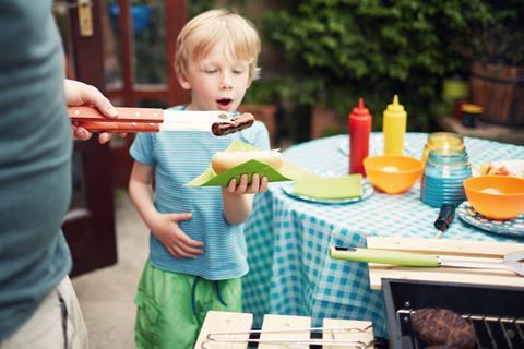 Family barbecue child boy hot dog bbq summer party GettyImages-645386675 (2)