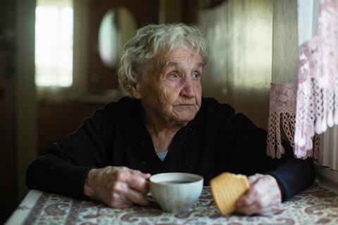 elderly lady with tea and biscuit